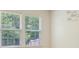 Bedroom with sunlit windows overlooking leafy trees, and a wall with inspiring calligraphy art at 1273 Discovery Dr, Ladson, SC 29456