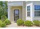 Welcoming entryway with a stylish front door, sidelight, and manicured landscaping at 1273 Discovery Dr, Ladson, SC 29456