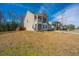 Beautiful home showcasing a well-kept lawn, and a two-car garage, under a bright blue sky at 1273 Discovery Dr, Ladson, SC 29456