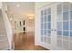 Welcoming foyer with hardwood floors, staircase, and double glass doors leading to office space at 1273 Discovery Dr, Ladson, SC 29456