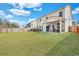 Beautiful backyard features a large lawn and screened-in porch for enjoying the outdoors at 130 Wappoo Trace Ln, Summerville, SC 29486