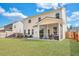 Expansive backyard featuring a patio with furniture, a screened porch, and lush greenery at 130 Wappoo Trace Ln, Summerville, SC 29486