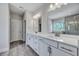 Spacious bathroom featuring a double vanity with a large mirror and shower with a glass door, creating a spa-like experience at 130 Wappoo Trace Ln, Summerville, SC 29486