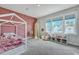 Bright ' bedroom features a pink accent wall, white canopy bed, and large sunny windows at 130 Wappoo Trace Ln, Summerville, SC 29486