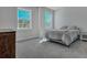 Sun-filled bedroom with two bright windows, neutral colors, and plush carpet at 130 Wappoo Trace Ln, Summerville, SC 29486