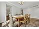 The dining room features a table for six with decorative centerpiece and chandelier lighting at 130 Wappoo Trace Ln, Summerville, SC 29486