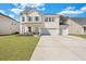 Charming two-story home with a well-manicured lawn, inviting porch, and three-car garage at 130 Wappoo Trace Ln, Summerville, SC 29486