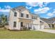 Charming two-story home featuring a well-manicured lawn, three car garage, and inviting front porch at 130 Wappoo Trace Ln, Summerville, SC 29486