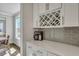 Stylish kitchen with quartz countertops, gray subway tile backsplash and a wine rack at 130 Wappoo Trace Ln, Summerville, SC 29486