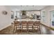 Bright, modern kitchen with a large island, pendant lighting, stainless steel appliances, and wicker chairs at 130 Wappoo Trace Ln, Summerville, SC 29486