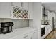 Chic kitchen showcasing quartz countertops, gray backsplash, and a wine rack for added elegance at 130 Wappoo Trace Ln, Summerville, SC 29486