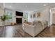Bright living room features large windows, modern fireplace, and beautiful hardwood floors at 130 Wappoo Trace Ln, Summerville, SC 29486