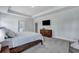 Spacious main bedroom featuring a TV, tray ceiling and modern decor, offering a comfortable living space at 130 Wappoo Trace Ln, Summerville, SC 29486