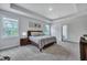 Spacious main bedroom with lots of natural light, carpet and a comfortable king-sized bed, creating a relaxing retreat at 130 Wappoo Trace Ln, Summerville, SC 29486