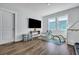 Well-lit playroom featuring mounted TV, play structures and hardwood floors at 130 Wappoo Trace Ln, Summerville, SC 29486