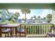 Relaxing balcony with outdoor seating, offering a peaceful view of the lush landscape and parking area at 1300 Ocean Blvd # 114 A, Isle of Palms, SC 29451