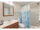 Bathroom featuring a sink with wood vanity and a shower and tub with a blue and white shower curtain at 1300 Ocean Blvd # 114 A, Isle of Palms, SC 29451