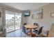 Inviting dining area with balcony access, perfect for enjoying meals with a view and natural light at 1300 Ocean Blvd # 114 A, Isle of Palms, SC 29451