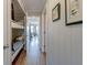 Long hallway with wood floors, bunkbeds on the left, and leading to the living room in the back at 1300 Ocean Blvd # 114 A, Isle of Palms, SC 29451