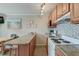 Well-equipped kitchen with modern appliances, granite countertops and breakfast bar with stools at 1300 Ocean Blvd # 114 A, Isle of Palms, SC 29451