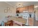 Functional kitchen featuring granite countertops, wood cabinets, and essential appliances for convenient meal preparation at 1300 Ocean Blvd # 114 A, Isle of Palms, SC 29451