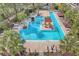 Expansive aerial view of the resort-style community pool, showcasing the pool layout, landscaping, and lounge areas at 135 Pier View St # 203, Charleston, SC 29492