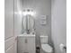 Stylish powder room with modern vanity, mirror, and toilet for guests at 135 Pier View St # 203, Charleston, SC 29492