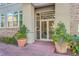 Welcoming building entrance with brick walkway, lush planters, and glass doors, providing an inviting access at 135 Pier View St # 203, Charleston, SC 29492