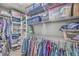 Organized walk-in closet with shelving and hanging rods for efficient storage solutions at 135 Pier View St # 203, Charleston, SC 29492
