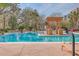 Beautiful pool area with lounge chairs, a central pergola, and lush landscaping, creating a relaxing oasis at 135 Pier View St # 203, Charleston, SC 29492