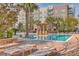 Luxurious community pool area with lounge chairs, palm trees, and well-maintained landscaping, perfect for relaxation at 135 Pier View St # 203, Charleston, SC 29492