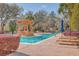 Inviting community pool with lounge chairs, colorful landscaping, and shade umbrellas, offering a relaxing retreat at 135 Pier View St # 203, Charleston, SC 29492