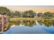 Scenic view of the community pond, reflecting the surrounding buildings and lush greenery, offering a tranquil setting at 135 Pier View St # 203, Charleston, SC 29492