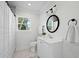 Bathroom with framed mirror, tiled floors, and shower at 1409 Main St, Bonneau, SC 29431