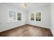 Bedroom featuring three windows and hardwood floors at 1409 Main St, Bonneau, SC 29431