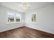 Bedroom featuring hardwood floors, three bright windows, and ceiling fan at 1409 Main St, Bonneau, SC 29431