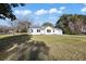 Beautiful single-story house with white siding, a well-manicured lawn, and an attached garage on a sunny day at 1409 Main St, Bonneau, SC 29431