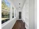 Sunroom with a dark wood floor and plenty of natural light from the windows at 1409 Main St, Bonneau, SC 29431