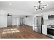 Bright kitchen featuring stainless steel appliances, hardwood floors, and modern lighting at 1409 Main St, Bonneau, SC 29431