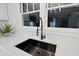 Modern kitchen sink with black faucet, quartz countertop, and bright window at 1409 Main St, Bonneau, SC 29431