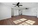 Large open living room with wood floors, ceiling fans, and multiple doorways to other rooms at 1409 Main St, Bonneau, SC 29431