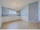 Airy dining room features light wood flooring and decorative wainscoting and a modern light fixture creating a warm ambiance at 143 Moon Dance Ln, Summerville, SC 29483
