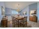 Cozy dining room with seating for six, featuring new flooring, light fixture, and wainscoting making it ideal for gatherings at 143 Moon Dance Ln, Summerville, SC 29483