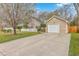 View of a single story home with an attached garage and blossoming tree at 143 Moon Dance Ln, Summerville, SC 29483