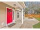 Inviting front porch with a red door and a cozy outdoor seating area at 143 Moon Dance Ln, Summerville, SC 29483