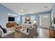 Staged living room with modern decor, including a TV and comfortable seating area at 143 Moon Dance Ln, Summerville, SC 29483