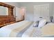 Light-filled bedroom showcasing a comfortable bed with an open doorway and large dresser at 1543 Scott Hill Rd, James Island, SC 29412