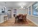 Bright dining area with stylish chairs, a wooden table, and an elegant chandelier next to the modern kitchen at 1543 Scott Hill Rd, James Island, SC 29412