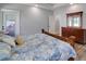 Bedroom featuring a wooden bed with floral comforter, hardwood floors, and natural light at 1543 Scott Hill Rd, James Island, SC 29412