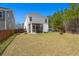 A large backyard with a screened porch, play structure, and fire pit provides a great outdoor living space at 162 Cherry Grv Dr, Summerville, SC 29483